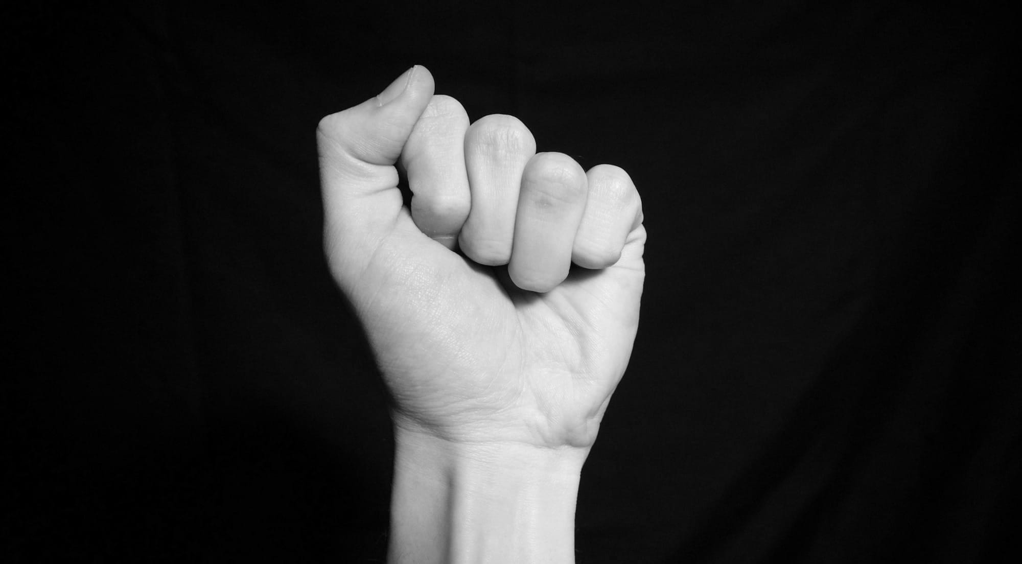 persons left hand on black textile