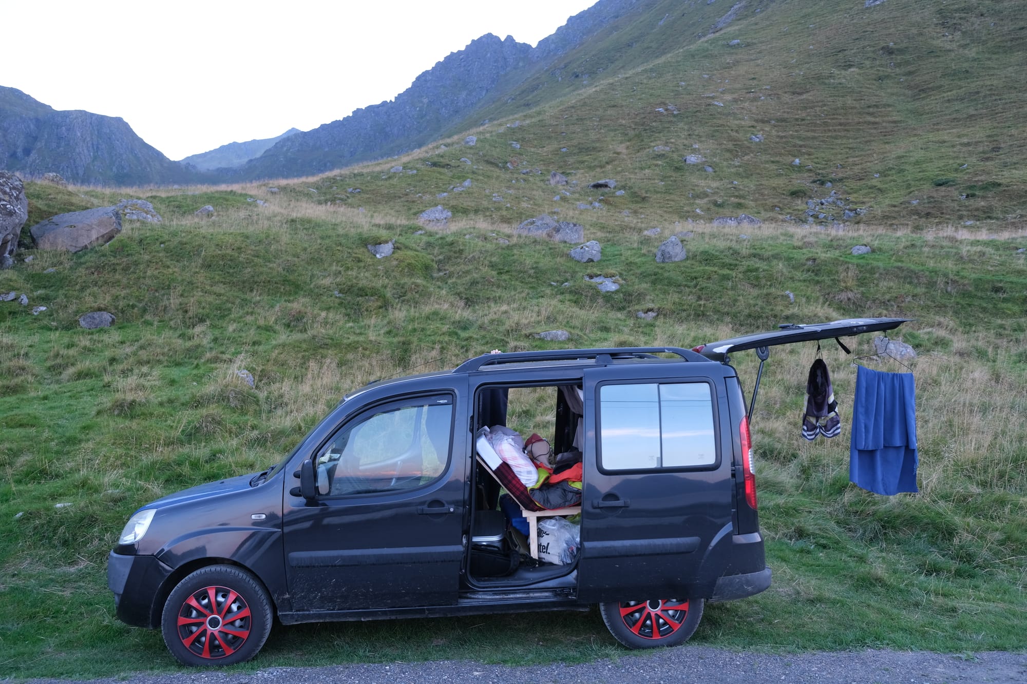 Lotte parked at an improvised roadside camp spot in Norway with a surprisingly scenic view, showing spontaneous wildcamping in action