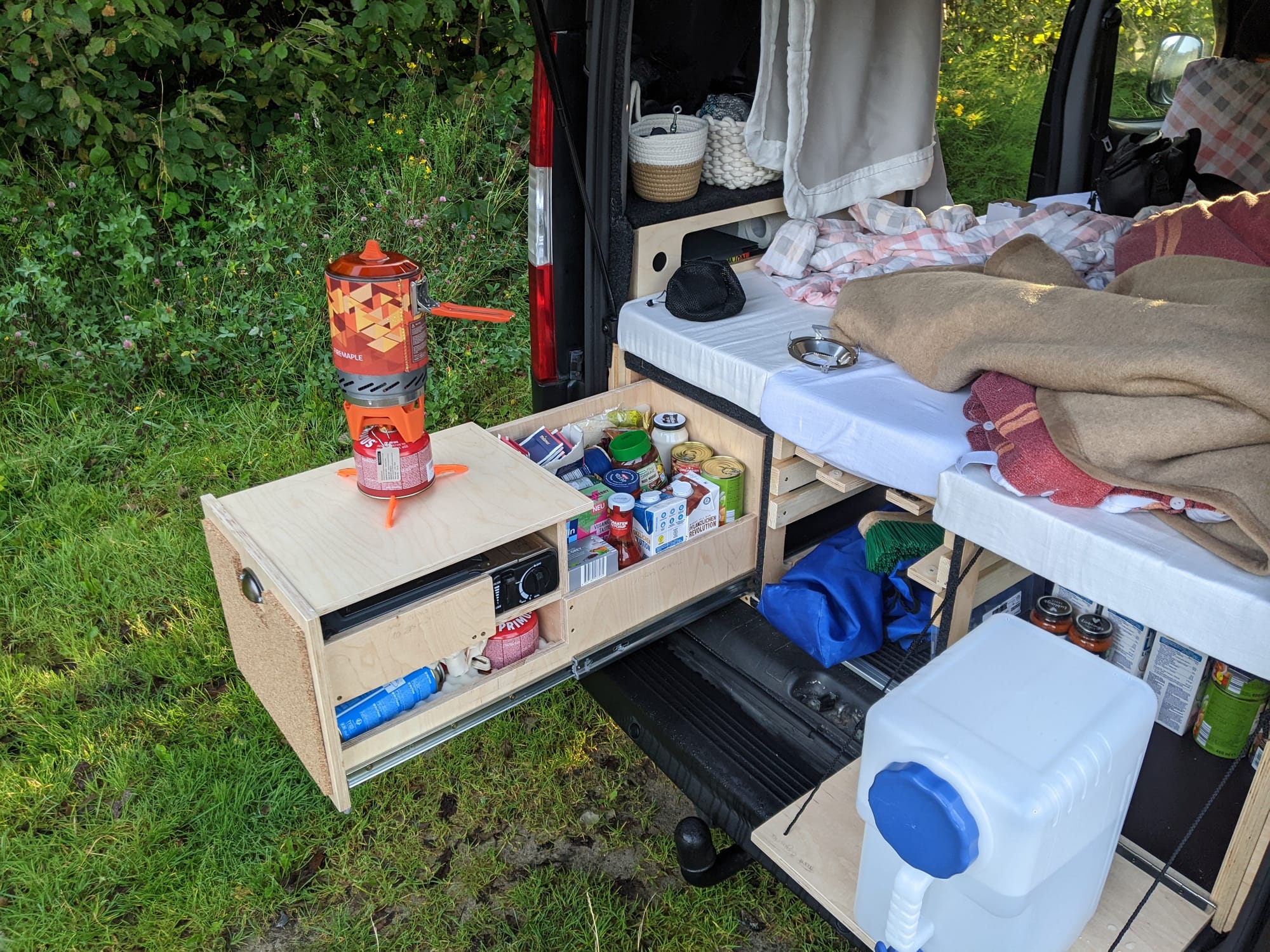 The back of Lotte packed with food supplies and camping gear at the start of our Norway trip, illustrating the storage challenges of a microcamper